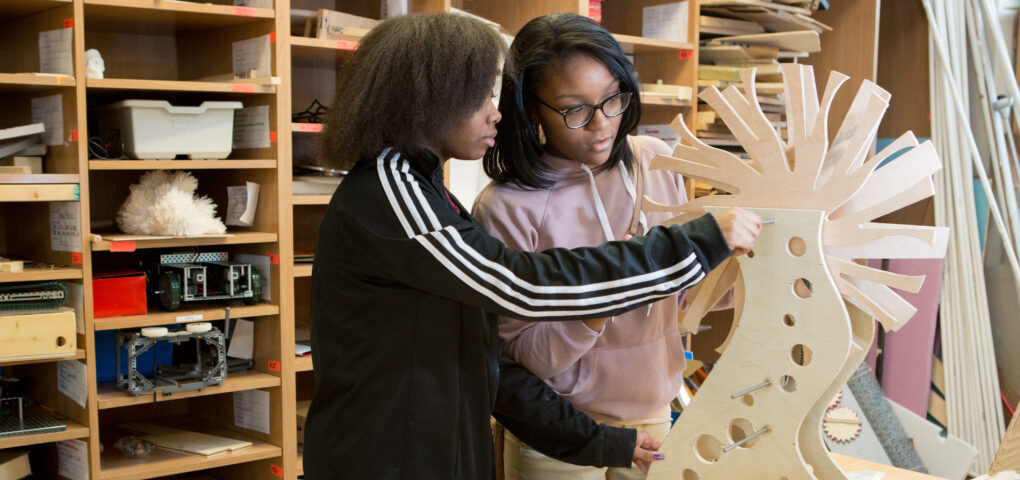 Tenth graders at MC2 STEM High School fit together their capstone project, which combines art and engineering.